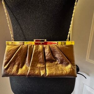 Darling bronze colored purse. Snap closer. Gold link chain strap. Medium size
